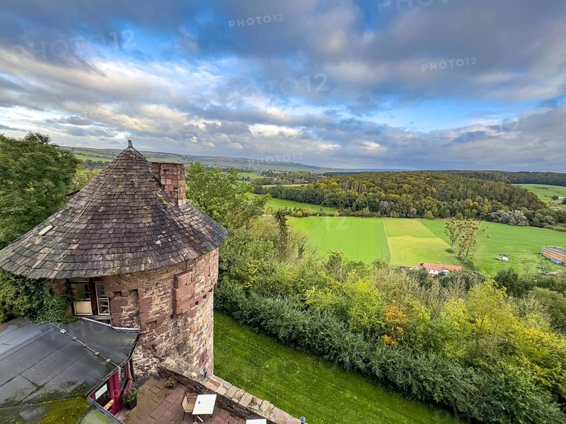 View from Trendelburg Castle to shingle roof of castle tower in the foreground behind green valley with river Diemel in North Hesse, Trendelburg, Hesse, Germany, Europe