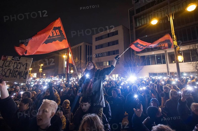 Sea of lights with flags Revolution at the demonstration under the motto Brandmauer statt Brandstifter / Asylrecht verteidigen in front of the Konrad-Adenauer-Haus, the party headquarters of the CDU, after a joint vote by the CDU/CSU and AfD in favour of a stricter migration policy introduced by party chairman Friedrich Merz. Berlin, 30.01.2025