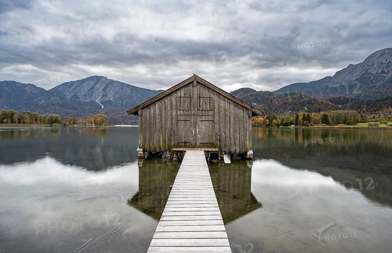 Boathouse in the lake, Lake Kochel in autumn with reflection, Upper Bavaria, Bavaria, Germany, Europe