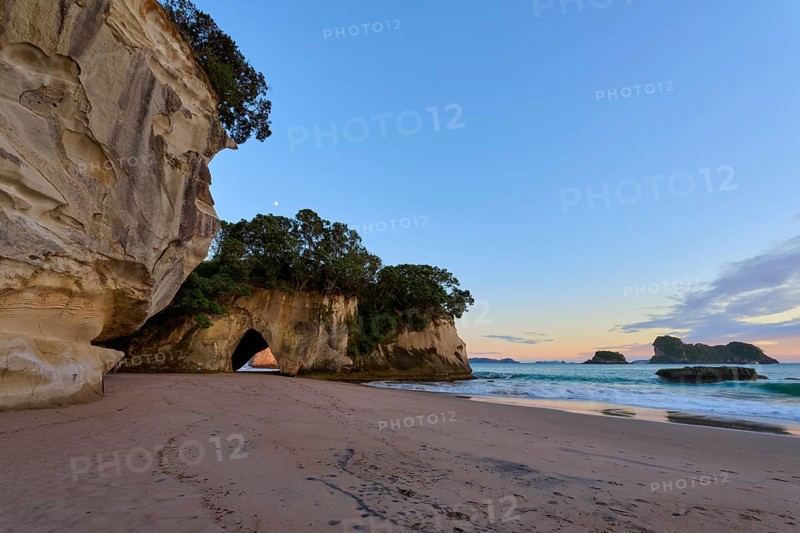 Sandy beach beach with rock and cave views, surrounded by calm seas and clear skies, Cathedral Cove, Coromandel, Canterbury, North Island, New Zealand, Oceania