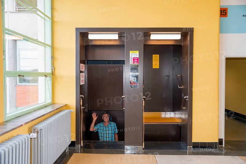 Man waving in a paternoster lift, in Batuv mrakodrap, Batas skyscraper, Zlín, Zlin, Zlínský kraj, Moravia, Czech Republic, Europe