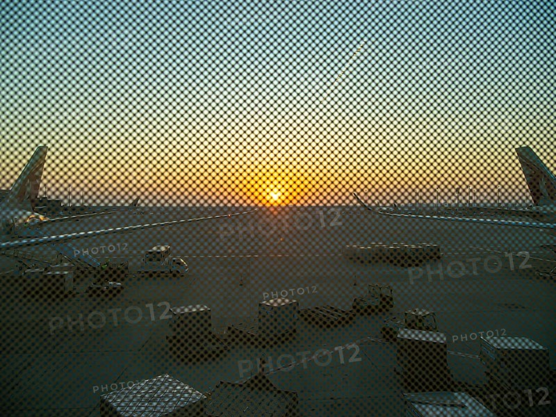 Berlin BER Airport, view through perforated window panes, taxiway at sunrise in November, Berlin, Germany, Europe