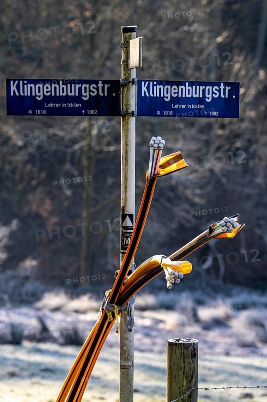Fibre optic connection, empty conduits protrude from the ground along a dirt track, into which the actual fibre optic cable is later blown and connected to the respective house connection or distributor, provision of fast Internet in rural areas, in the south of Mülheim an der Ruhr, North Rhine-Westphalia, Germany, Europe