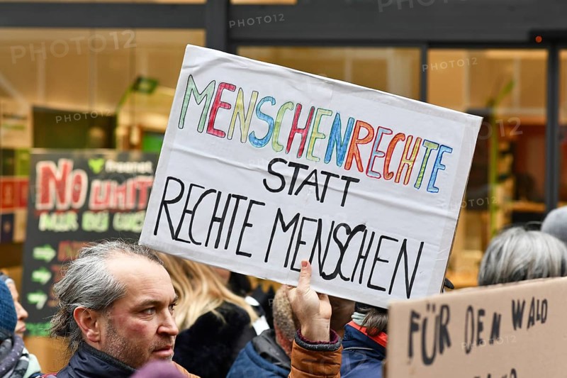 Heidelberg, Germany - February 12th 2025: Person holding up sign with text 'Human rights instead of right people' in crowd at protest against far-right