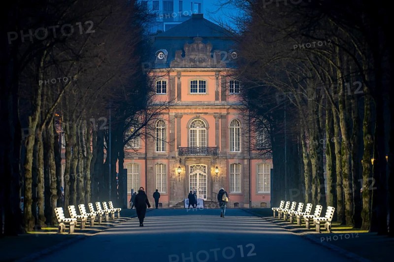 The light benches by artist Stefan Sous in the Hofgarten, entitled UV-A UV-B, 14 completely refurbished exhibits from the 2002 light-grey art exhibition, which now stand and light up as a permanent work of art on Jägerhofallee, LED technology, in the background Jägerhof Palace, home of the Goethe Museum, Düsseldorf, North Rhine-Westphalia, Germany, Europe