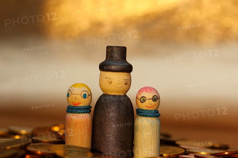Three wooden cones standing in euro coins, North Rhine-Westphalia, Germany, Europe