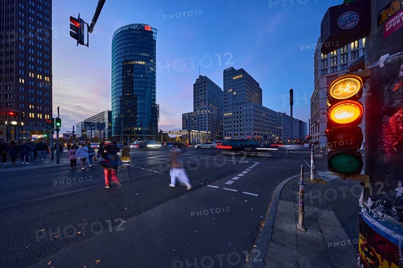 Cyclist traffic light, pedestrian crossing, pedestrian with motion blur and railway tower at blue hour at Potsdamer Platz, dusk in Berlin, capital, independent city, federal state Berlin, Germany, Europe