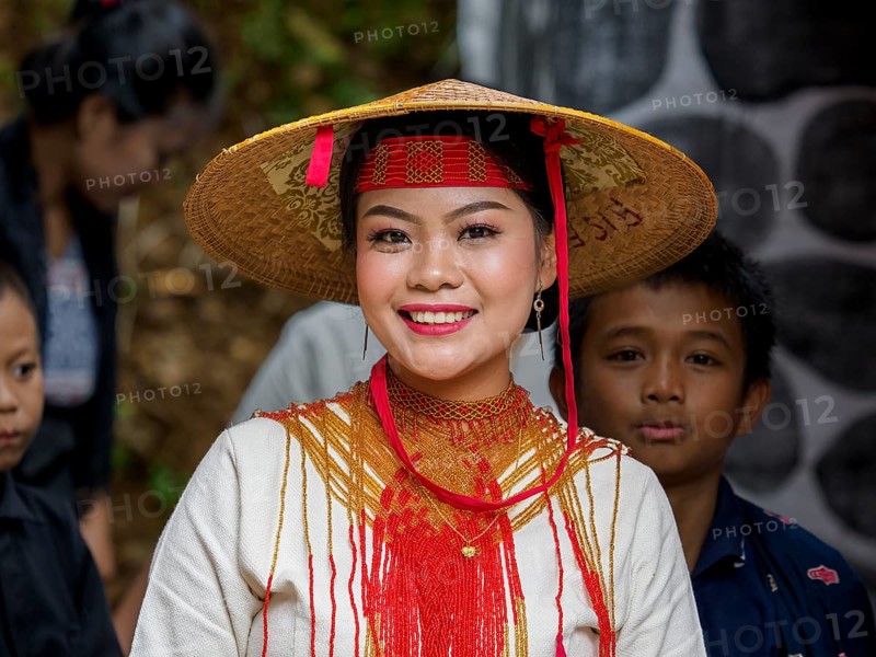 Toraja woman in traditional colourful clothes with rice straw hat, smiling, portrait, Tana Toraja, Rantepao, Sulawesi, Indonesia, Asia