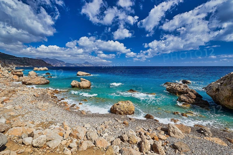 Stony coast with large rocks, turquoise blue sea and light cloud cover, Kato Lakkos Beach, still almost unspoilt bay, not accessible by car, Kato Lakkos, east coast, Karpathos, Dodecanese, Greek Islands, Greece, Europe