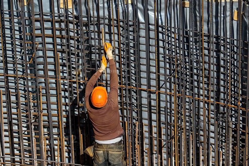 Essen, North Rhine-Westphalia, Germany, construction industry, construction workers working on a building site. Iron binder is a job title for construction workers who bind reinforcing mesh for the reinforcement of concrete parts. The meshes are prepared together with the formwork builder to form moulds, which are then filled with fresh concrete, Europe