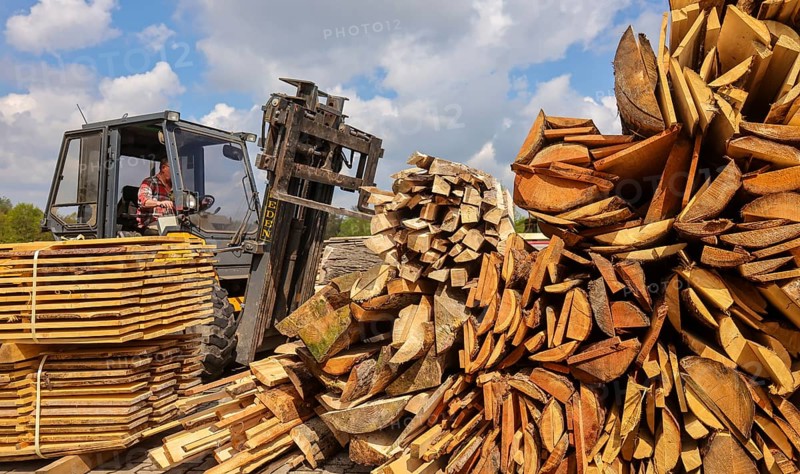 Solingen, North Rhine-Westphalia, Germany - Residual wood in the timber store of a sawmill is processed into wood chips and used as fuel in a combined heat and power plant, construction timber is scarce and expensive, carpentry and joinery companies are struggling with rapidly rising raw timber prices in times of the corona crisis, large quantities of logs are exported to China and the USA