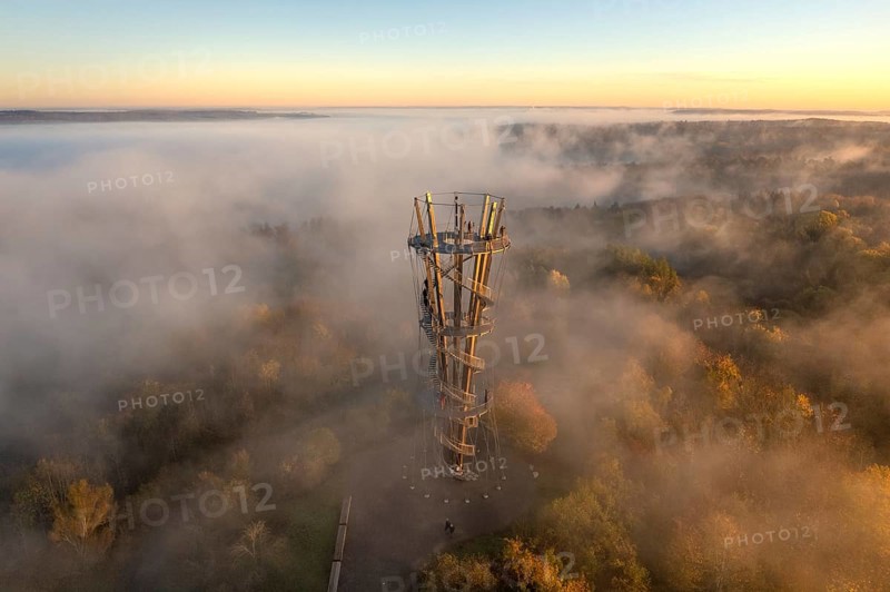 Tower in the fog reveals itself at sunrise, surrounded by autumnal forest landscape, Schönbuchturm, Herrenberg, Germany, Europe