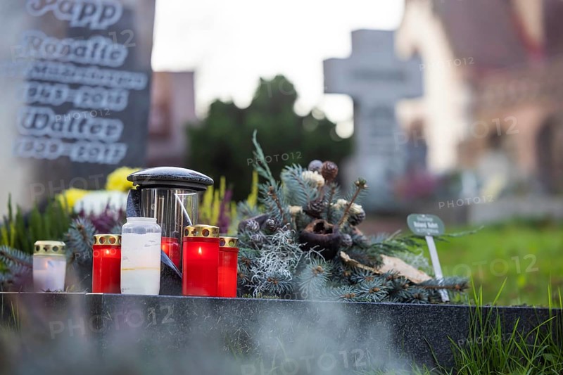All Saints' Day at the Bergfriedhof cemetery in Stuttgart. Catholics commemorate their deceased relatives. Grave decorations and candles. Stuttgart, Baden-Württemberg, Germany, Europe