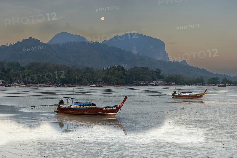 Before sunrise, longtail boats lie at low tide in the harbour at Sivalai Beach, Koh Mook Island, Satun Province, Southern Thailand, Thailand, Asia