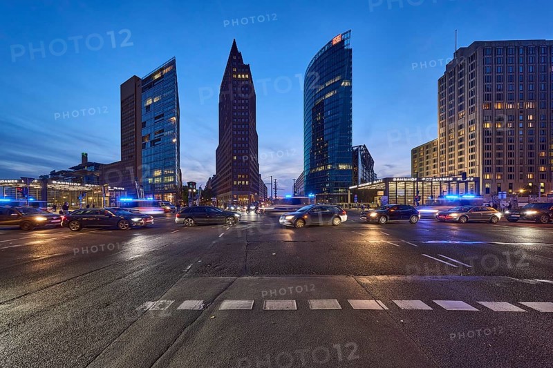 Police operation with blue light, vehicles with motion blur, skyscrapers Forum Tower, Kollhoff Tower and Bahntower in the blue hour at Potsdamer Platz, dusk in Berlin, capital, independent city, federal state Berlin, Germany, Europe