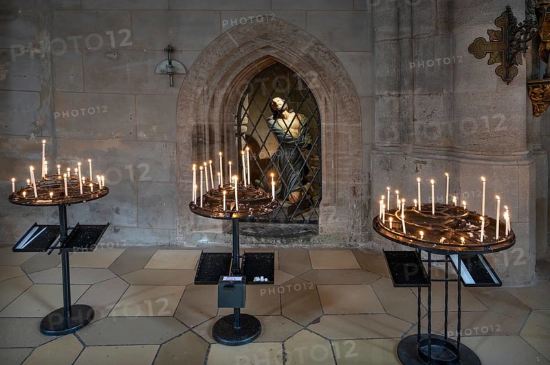 Sacrificial candles, a figure of Jesus at the back in the late Gothic hall church of St George, Dinkelsbühl, Bavaria, Germany, Europe