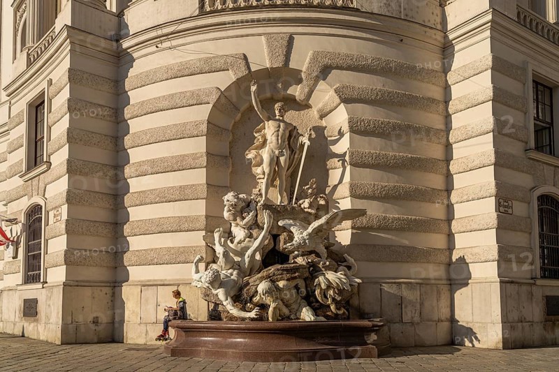 Fountain sculpture Die Macht zu Lande, St Michael's Wing of the Hofburg Imperial Palace Palace in Vienna, Austria, Europe