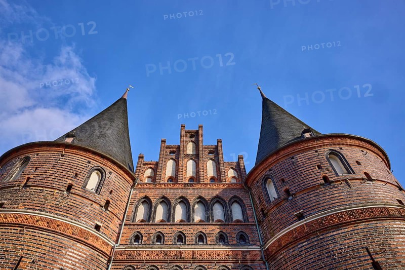 City gate, historic brick building, round towers with slate roof, gable, frog perspective, Hanseatic city of Lübeck, independent city, Schleswig-Holstein, Germany, Europe