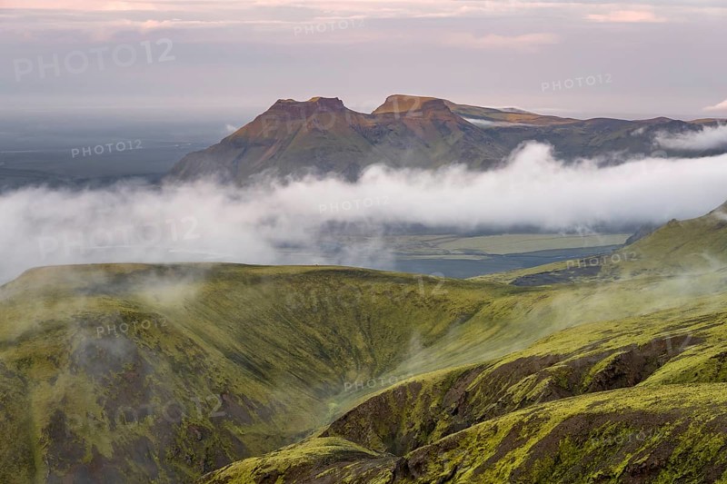 Fog between mountains, moss-covered volcanic mountain landscape, at sunset, Pakgil, Iceland, Europe
