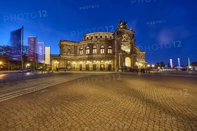 Semperoper, architectural style neo-renaissance, architect Gottfried Semper, flags with programme of the Dresden State Opera, motion blur, evening blue hour, Theaterplatz, Dresden, state capital, independent city, Saxony, Germany, Europe
