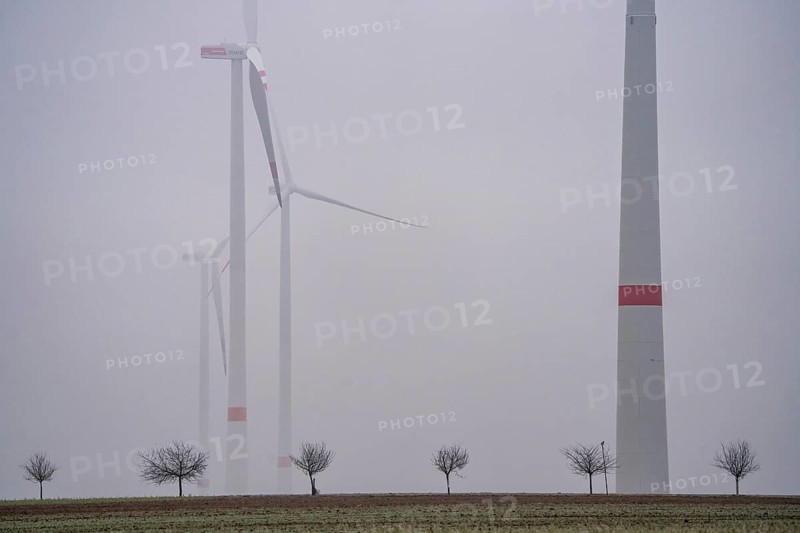 Wind farm in fog, dark doldrums, no wind no direct sunlight, in the Rhenish lignite mining area, south of the Garzweiler open-cast mine near Bedburg, North Rhine-Westphalia, Germany, Europe