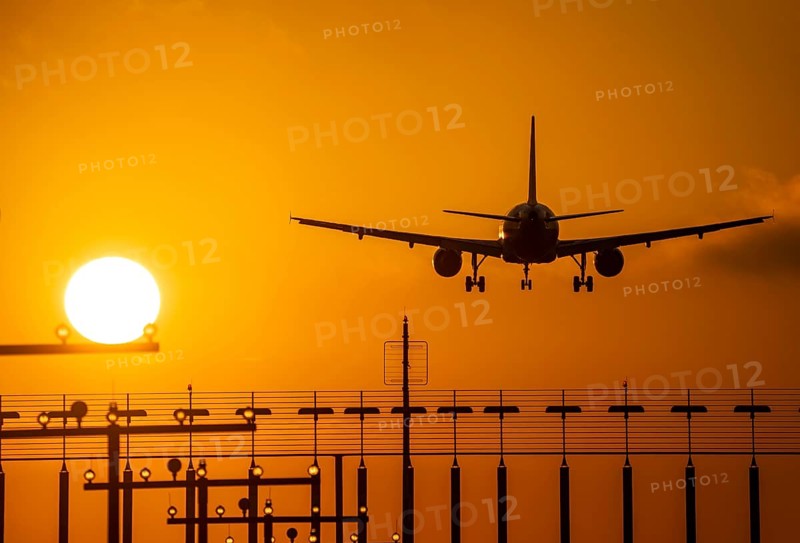Aircraft approaching the main runway south, 05R/23L, runway lighting, approach aids, at Düsseldorf International Airport, sunset, North Rhine-Westphalia, Germany, Europe