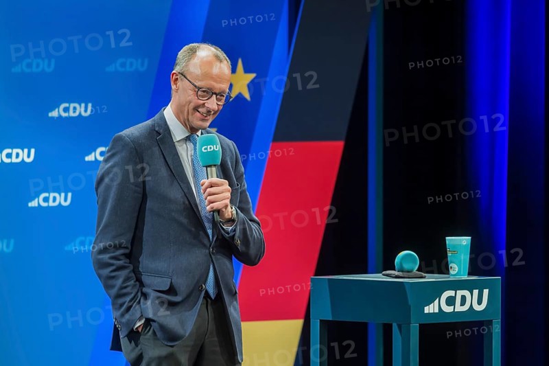 Election event of the CDU party for the Bundestag elections with top candidate Friedrich Merz. Portrait in front of the German flag and the flag of the European Union. Singen am Hohentwiehl. Baden-Württemberg, Germany, Europe