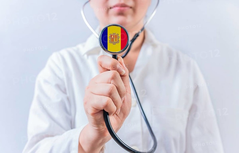 Female doctor holding stethoscope with Andorra flag. National Health System of Andorra
