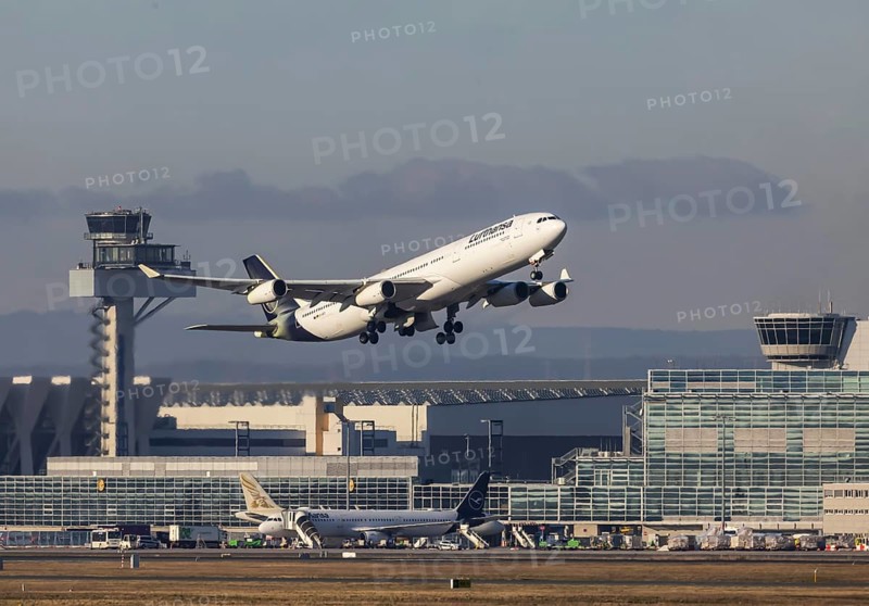 Aircraft takes off in front of the terminal and tower at Fraport Airport. Aircraft registration number: D-AIFC, Airbus A340, Lufthansa. Frankfurt am Main, Hesse, Germany, Europe