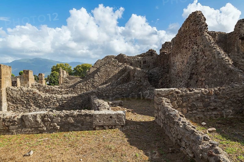 Old stone wall structures of varying heights and remnants of residential buildings at the ancient ruins of Pompeii, Campania region, Italy, Europe