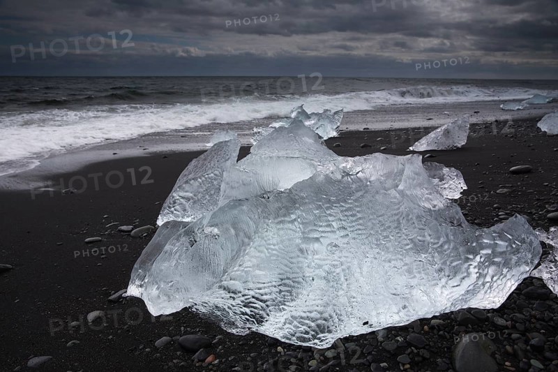Little icebergs and crushed ice on the black beach at Joekulsarlon glacial lake