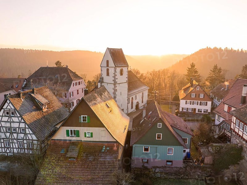 Church and half-timbered houses in a village in the evening light, surrounded by forest and idyll, Zavelstein, district of Calw, Black Forest, Germany, Europe
