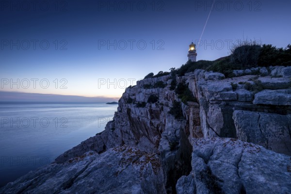 Lighthouse on a steep cliff at dusk, overlooking the vast sea, Lastovo, Neretva, Croatia, Europe