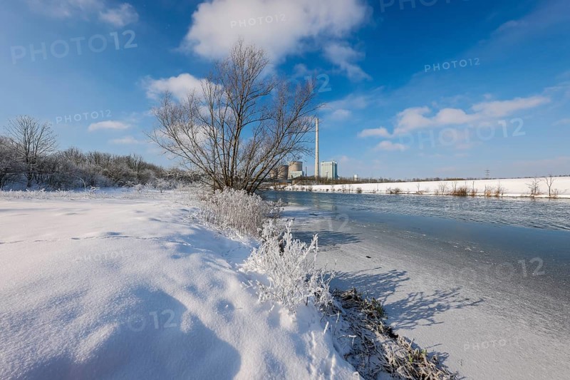 Hamm, North Rhine-Westphalia, Germany - Sunny winter landscape in the Ruhr area, ice and snow on the river Lippe, behind the RWE gas-fired power station Gersteinwerk
