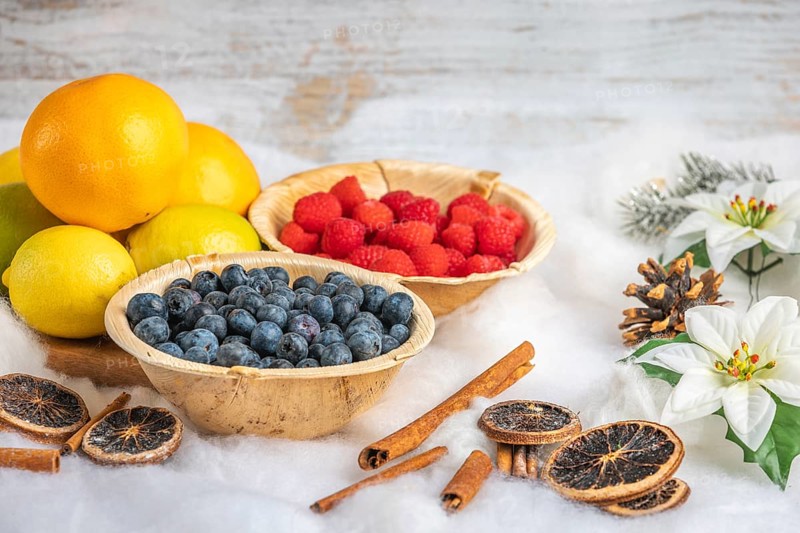 Healthy fruit and berries, white background, Christmassy decoration