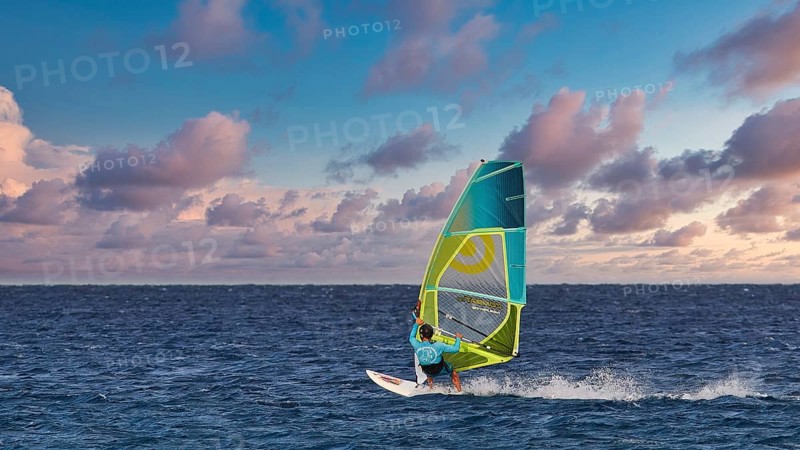 Sky exchanged, windsurfer gliding across the sea under a dramatic sky, windsurfer, Meltemi windsurfing spot, Devils Bay, Paralia Vatha, Vatha Beach, south-east coast, Karpathos, Dodecanese, Greek Islands, Greece, Europe