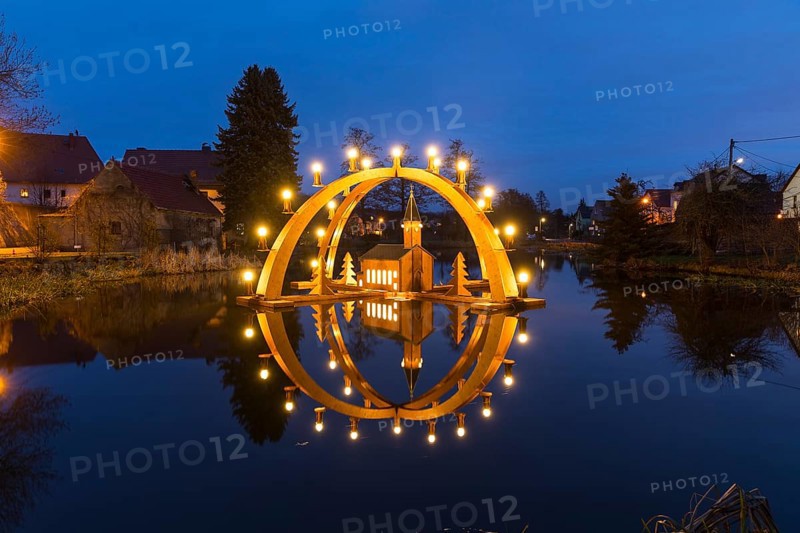 Floating double candle arch from the Ore Mountains with a model of the church on the village pond in Bärnsdorf, Radeburg, Saxony, Germany, Europe
