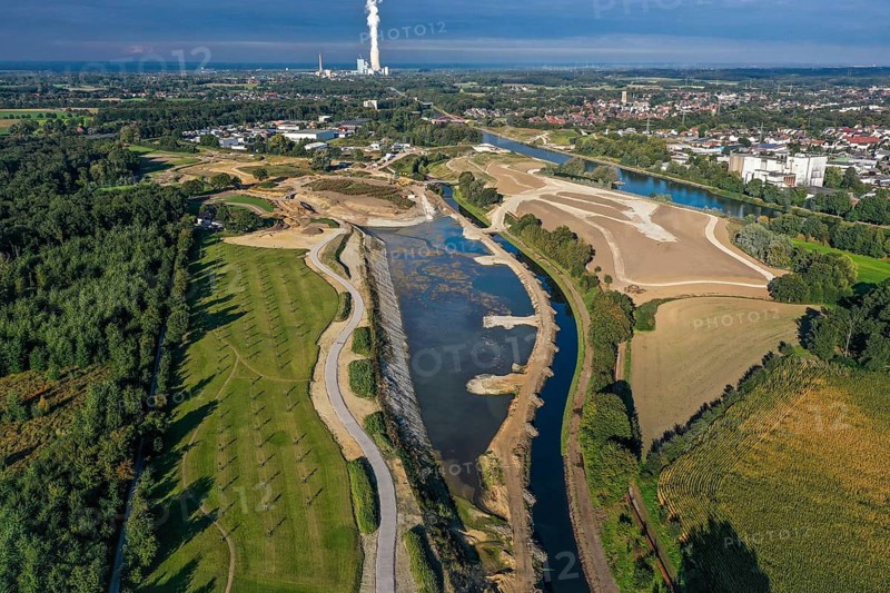 Recklinghausen, Castrop-Rauxel, North Rhine-Westphalia, Germany - EMSCHERLAND construction project, a 37-hectare water and nature discovery park at the water crossroads of the Rhine-Herne Canal and the renaturalised Emscher on the city boundary of Recklinghausen and Castrop-Rauxel. The ecological focal point at the confluence of Suderwicher Bach and Emscher will also be a future garden for the International Garden Exhibition 2027. Before the renaturalisation, the Emscher river system was an open, above-ground wastewater canal, combined sewer with surface water and wastewater. The Uniper power plant Datteln 4 in the background