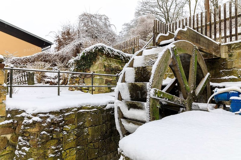 Small overshot waterwheel in the snow, Zschonermühle, Ockerwitz, Dresden, Saxony, Germany, Europe