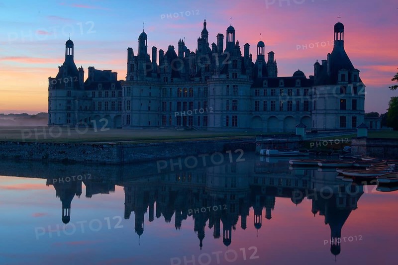 Chambord Castle with moat at sunrise, Chambord, Department Loir-et-Cher, Centre region, France, Europe