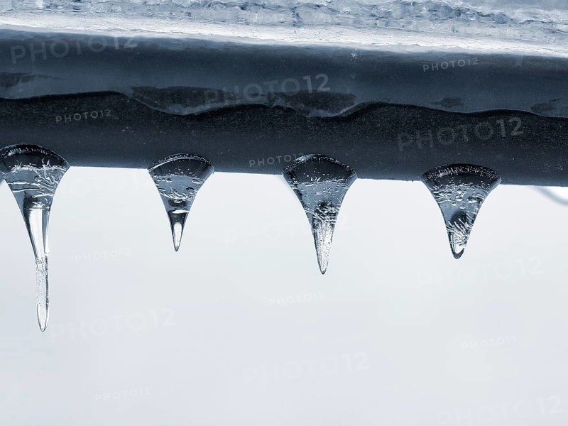 Four icicles hanging from a railing, macro, unusually cold winter 2010, symbolic photo winter weather, sub-zero temperatures, past, meteorology, Höxter, Germany, Europe
