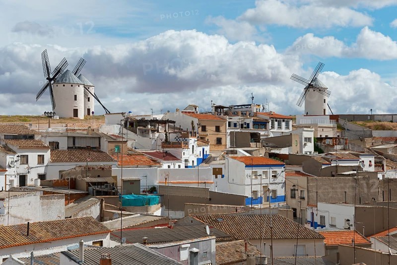 A town view with windmills and houses under a partly cloudy sky, Campo de Criptana, Ciudad Real province, Castilla-La Mancha, Don Quixote Route, Spain, Europe