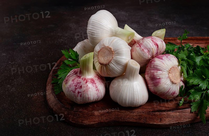 Fresh young garlic, white and purple color, on a wooden table, no people