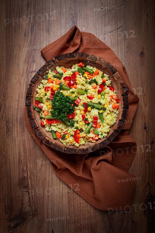 Couscous with vegetables, paprika, carrots, string beans, corn, homemade, top view, no people