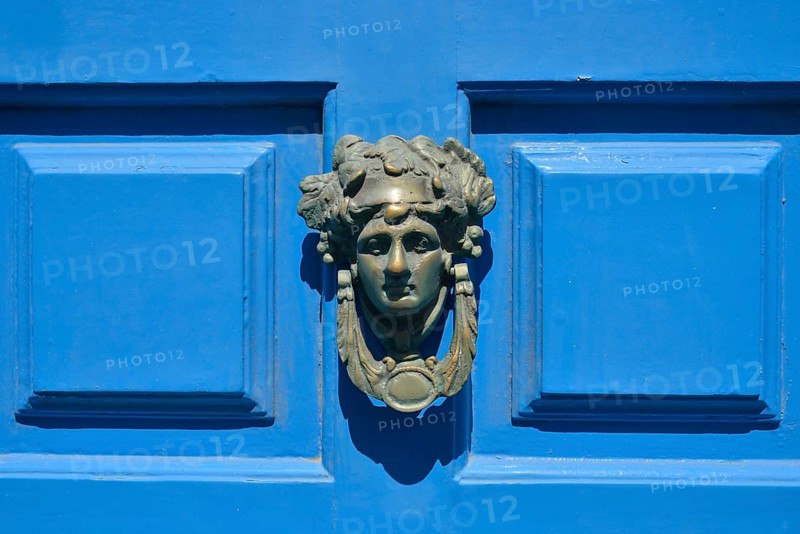 Head shaped door knocker on a blue door, Mykonos Town or Chora, Mykonos, Cyclades, Greece, Europe
