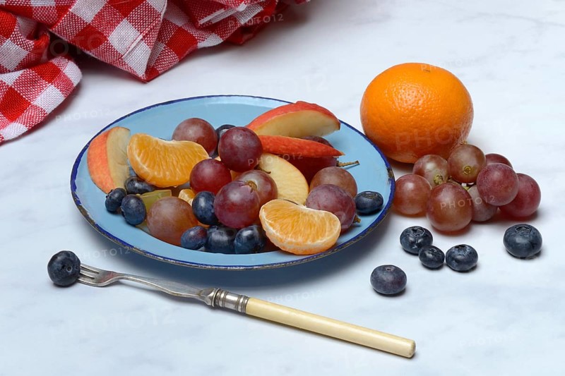 Various pieces of fruit on plate, fruit salad