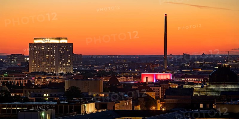 Charité high-rise hospital and the chimney of the Vattenfall combined heat and power plant Scharnhorststraße in the sunset, Berlin, Germany, Europe