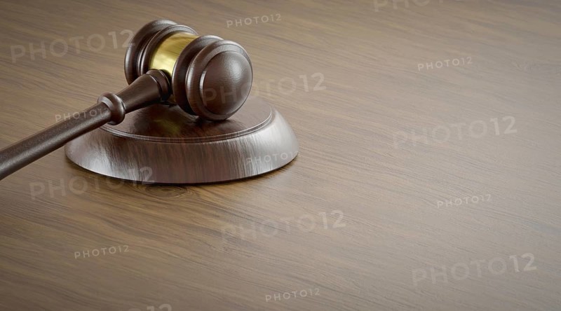 Gavel resting on a table with room for text