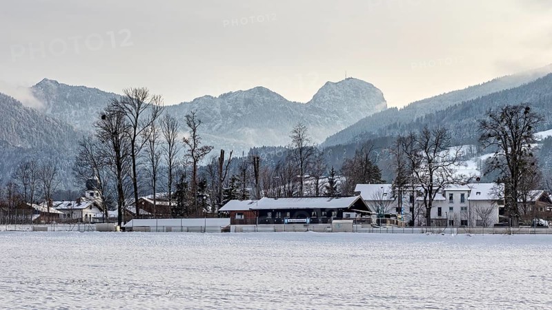 Snow-covered village in front of a mountain range with a peaceful winter atmosphere, Bad Feilnbach, Germany, Europe