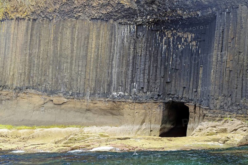 High basalt cliffs with a small cave on the coast, Hebrides Overture, Staffa Island, Inner Hebrides, Scotland, Great Britain